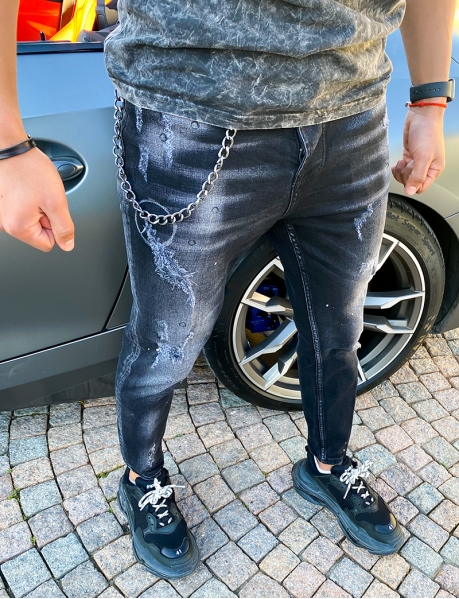 Ripped jeans with paint-style flecks and chain